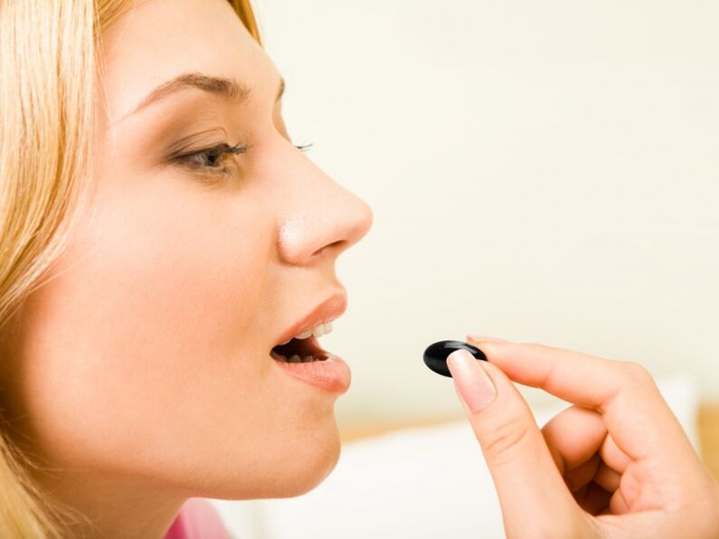 Girl takes medicine to prevent worms